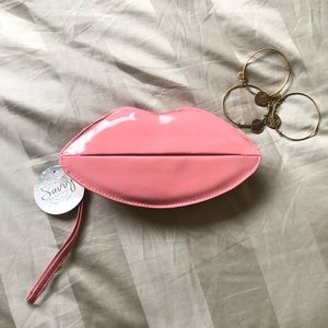 Savvy travelers kiss lips shaped clutch